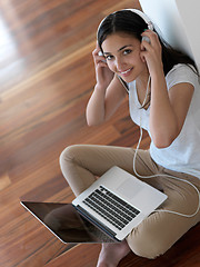 Image showing relaxed young woman at home working on laptop computer