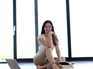 Image showing relaxed young woman at home working on laptop computer