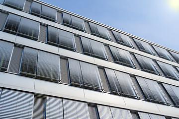 Image showing High-rise office building facade with covered windows Venetian b