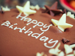 Image showing Happy birthday chocolate cake with white icing text