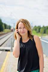 Image showing Young beautiful female talking on mobile phone