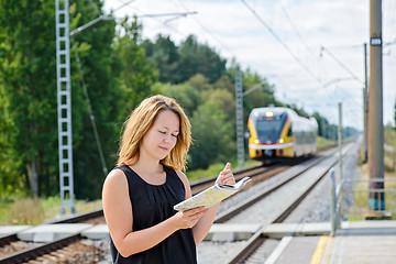 Image showing Female waiting train on the platform 