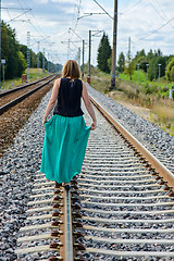 Image showing Young women walking on the rail track