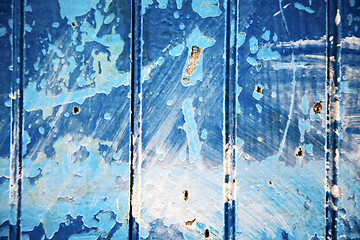 Image showing dirty   in the blue wood door and rusty nail