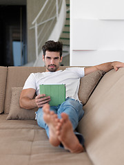 Image showing man using tablet computer from home