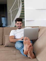 Image showing Man Relaxing On Sofa With Laptop