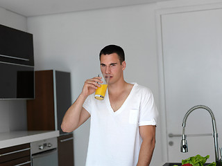 Image showing man cooking at home preparing salad in kitchen