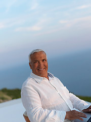 Image showing relaxed senior man on balcony