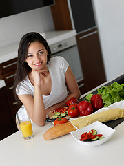 Image showing Young Woman Cooking in the kitchen