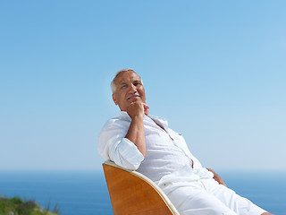 Image showing senior man sitting outside