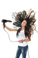 Image showing Female drying her hair with hair-drier