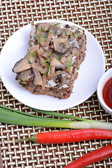 Image showing mushroom salad on white plate and red pepper
