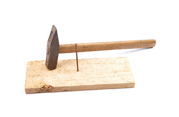 Image showing Hammer with nail and board