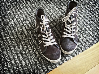 Image showing Fashionable shoes on gray striped carpet