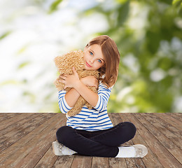 Image showing cute little girl hugging teddy bear