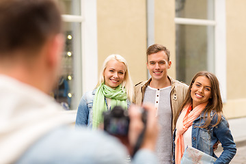 Image showing group of smiling friends taking photo outdoors