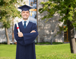 Image showing smiling adult student in mortarboard with diploma