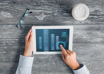 Image showing close up of hands with tablet pc and bitcoin