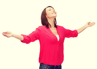 Image showing smiling woman waving hands with closed eyes