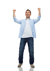 Image showing happy laughing man with raised hands