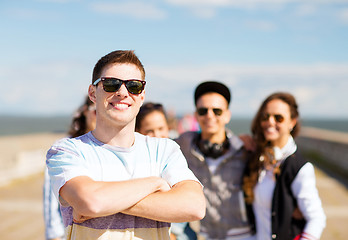 Image showing teenager in shades outside with friends