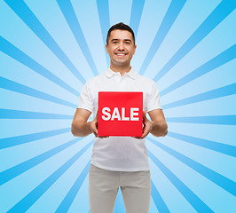 Image showing smiling man with red sale sigh