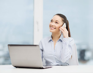 Image showing smiling businesswoman with laptop