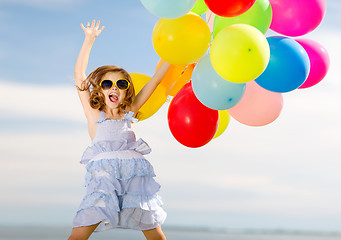 Image showing happy jumping girl with colorful balloons