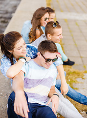 Image showing group of smiling teenagers hanging out