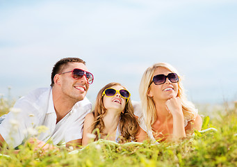 Image showing happy family with blue sky and green grass