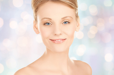 Image showing beautiful young woman face over blue background