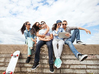 Image showing group of teenagers looking at tablet pc