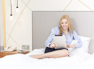 Image showing happy businesswoman with tablet pc in hotel room