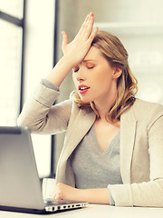 Image showing stressed woman with laptop computer