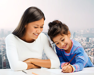 Image showing happy mother and daughter drawing with pencils