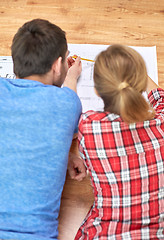 Image showing close up of couple with  blueprint at home