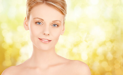 Image showing beautiful young woman face over yellow background