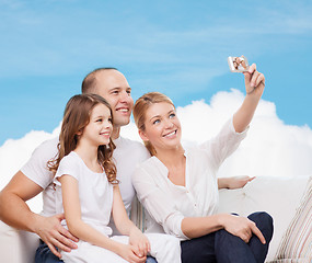 Image showing happy family with camera at home