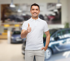 Image showing man showing thumbs up over auto show background