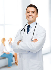 Image showing smiling male doctor in white coat at hospital