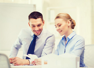 Image showing smiling business couple looking at color samples