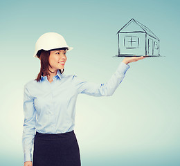 Image showing young smiling businesswoman in white helmet