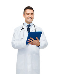 Image showing smiling male doctor in white coat with tablet pc