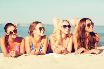 Image showing group of smiling women in sunglasses on beach