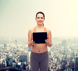 Image showing sporty woman with tablet pc blank screen