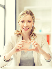Image showing young woman showing heart sign