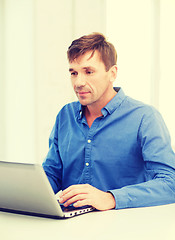 Image showing man working with laptop at home