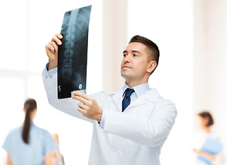 Image showing male doctor looking at x-ray in hospital