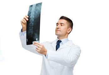 Image showing male doctor in white coat looking at x-ray