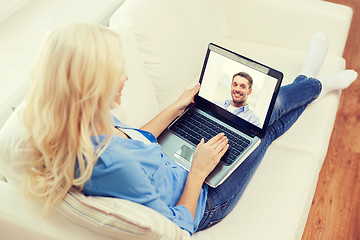 Image showing smiling woman with laptop computer at home